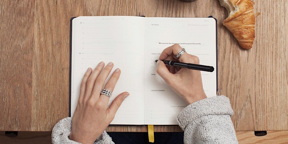 person writing in a book